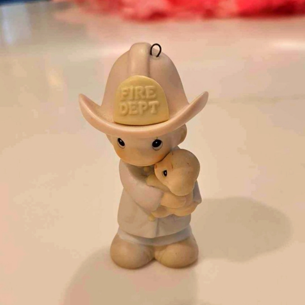 Precious moments fireman ornament.